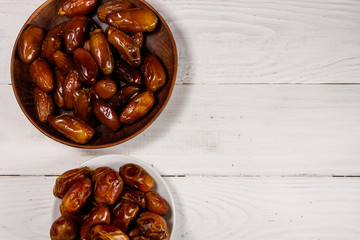 Dried dates fruit on white wooden table. Top view