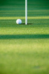 golf ball and pin amost in