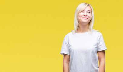 Young beautiful blonde woman wearing white t-shirt over isolated background smiling looking side and staring away thinking.