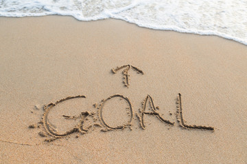 Message goal on the sand with upper arrow on sand at the beach