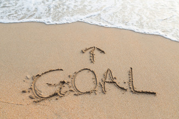 Message goal on the sand with upper arrow on sand at the beach
