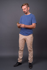 Blond bearded man with goatee against gray background