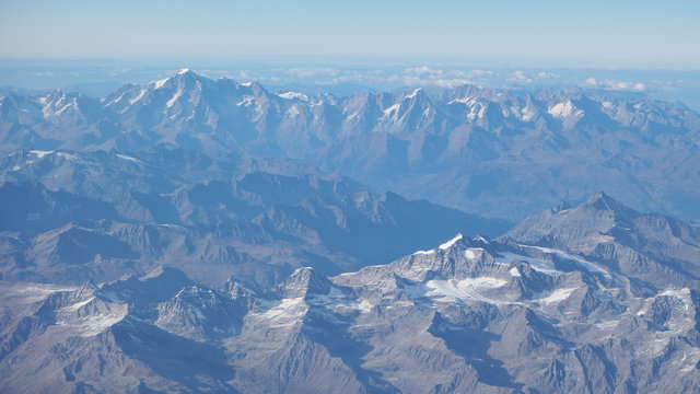 Fototapeta Flying over the European Alps during fall season. Landscape at the Mont Blanc and the glaciers. Aerial view from the airplane window