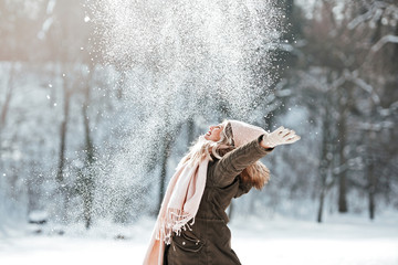 Beautiful young woman enjoying in the snow - Powered by Adobe