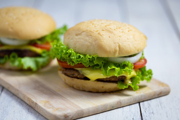 Homemade hamburgers on wooden board