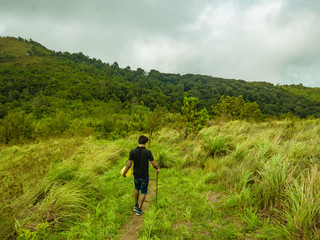 Back of Trekker walk in Khao Luang mountain  in Ramkhamhaeng National Park,Sukhothai province Thailand