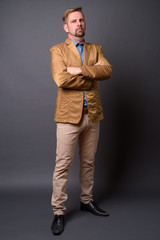 Blond bearded businessman with goatee against gray background