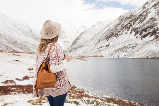 Woman traveler on the background of a beautiful mountain lake