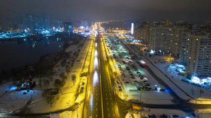 Fototapeta na wymiar Aerial view snow-covered road with cars in winter at night