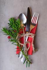 High Angle View of Silver Cutlery Set Wrapped in rope on Stylish grey background with copy space,...