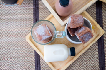 Chocolate ice cubes with bottle of milk