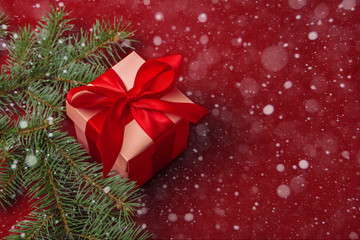 Christmas gifts with red ribbon on red background with decorations. Christmas background with copy space.