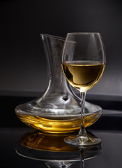 A glass full of wine and wine decanters