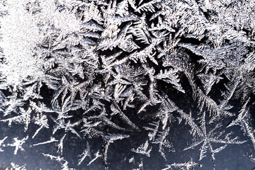 Frozen iced background. Ice pattern on the glass. Macro frost turn into negative black white photo