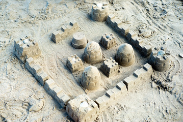 The sandcastle on the beach built by using the plastic models