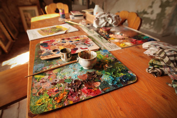 Naklejka na ściany i meble Palette with oil paints on a wooden table