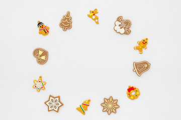 Christmas background.  Christmas frame made of gingerbread cookies on white background.  Creative flat lay, top view design
