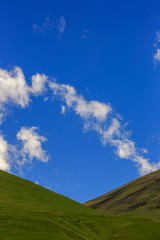 Stone ledge of a rocky ridge against the blue sky. Caucasian mountain range in Russia.