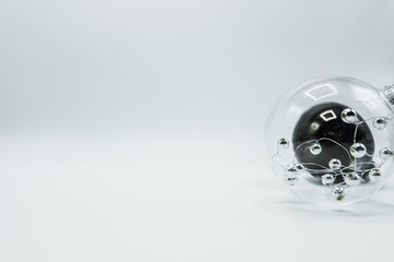 Transparent christmas ball with silver spheres and black bauble.