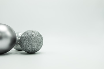 Monochrome Christmas decorations balls on grey.