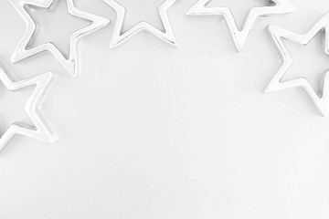 Christmas composition. Xmas silver stars on pastel gray background. Flat lay, top view, copy space 