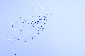 Christmas composition. Xmas glisten stars decorations on blue background. Flat lay, top view, copy...