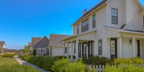 Homes with white fences and pathway in Daybreak UT