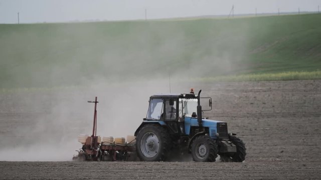 Tractor Plowing Field In Spring Season. Beginning Of Agricultural Season
