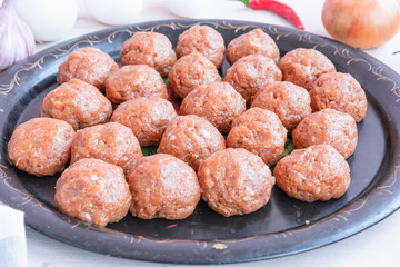 Swedish cuisine - raw swedish meatballs on a platter.