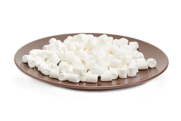 White small marshmallow on a brown dish