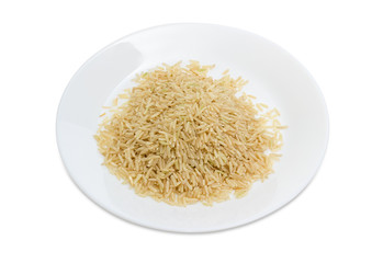 Uncooked brown rice on the white dish