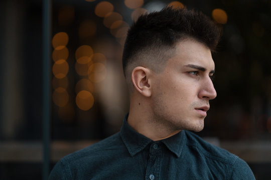 Young Man Profile Close Up Portrait With Lights In Background