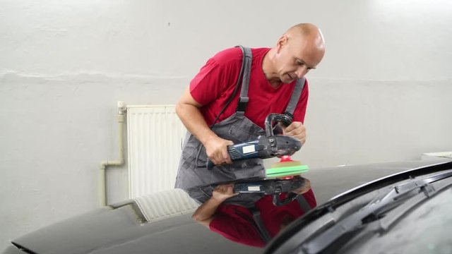 auto mechanic buffing car autobody
