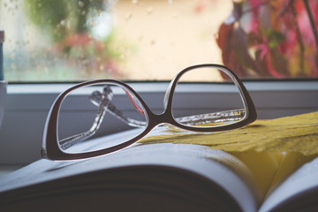 Eye glasses on the book close up.