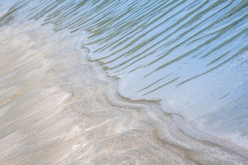 Blurred sea on the sand beach