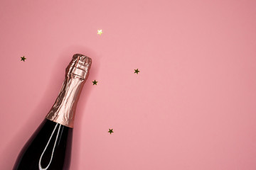 champagne bottle and confetti, flat lay, copy space © pauchi