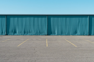 Empty parking lot and warehouse / storage unit - obrazy, fototapety, plakaty