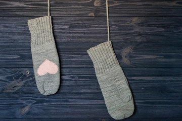 Knitted mittens on a blue wooden background.