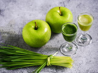 Detox juice with wheat grass and apple. Nutrition food concept. Healthy drinking.