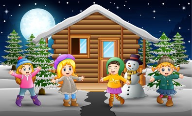 Cartoon of Happy kids wearing a winter clothes in front of the snowing village