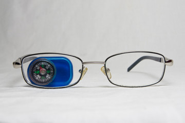 glasses and compass on a white background