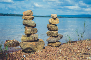 praying layers of stone on river side