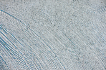 close up of white concrete wall with lines and curves