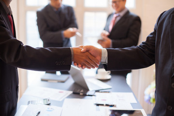 Asia business people shaking hands, finishing up meeting