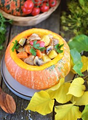 Vegetable stew with pork, potatoes, red pepper, carrots, mushrooms, eggplant in pumpkin.