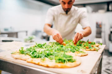Foto auf Glas Man making a pizza in restaurant. © OscarStock