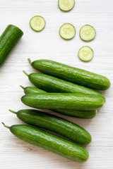Fresh raw organic green cucumbers, top view. Flat lay, from above, overhead. Close-up.