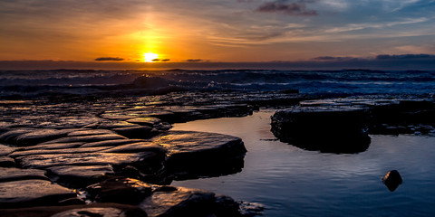 Rocks on pools of seawater in San Diego at sunset