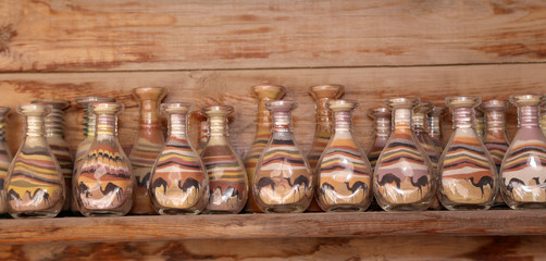 traditional local souvenirs in Jordan- bottles with sand and shapes of desert and camels