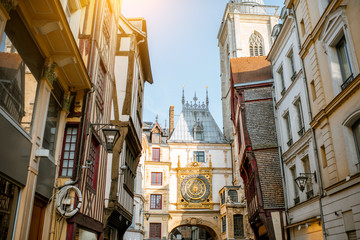 Street view with ancient buildings and Great clock on renaissance arch, famous astronomical clock...